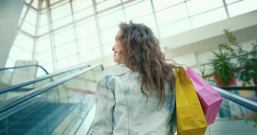 Stylish Woman Riding Escalator at Shopping Mall