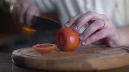 The Cook Cuts Fresh Red Tomatoes on the Wooden Board in a Bar in Slow Motion, Cooking Fresh Vgetable