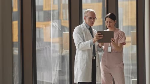 Doctors Examining Scan on Digital Tablet