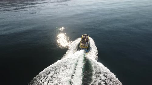 Boat Speeding Through Ocean Leaving White Trail