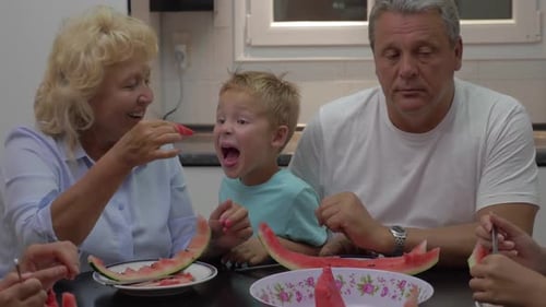 Family Enjoys Watermelon Together at Home
