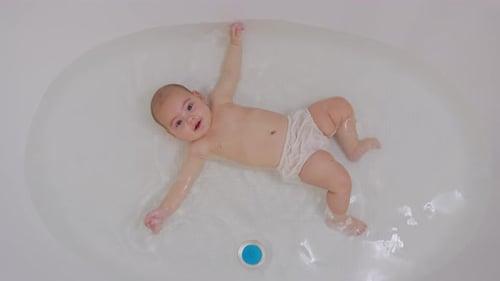 Top View of Funny Newborn Baby Swimming During Bathingю