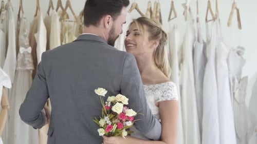 Happy Couple Embracing in Wedding Dress Shop