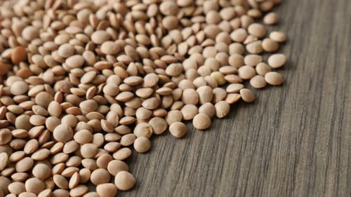 Close Up of Dried Brown Lentils on Wood