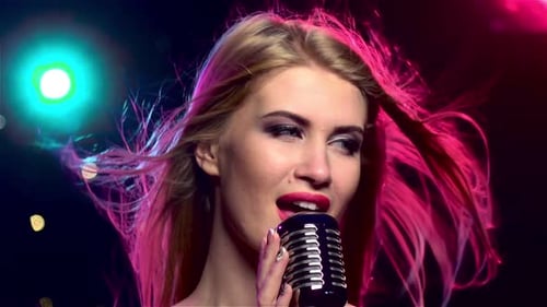 Singer Female with Retro Microphone, Long Hair Developing. Close Up. Slow Motion