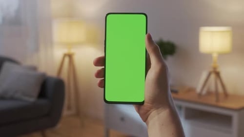 Point of View of Man Holding Chroma Key Green Screen Smartphone Watching Content Without Touching or