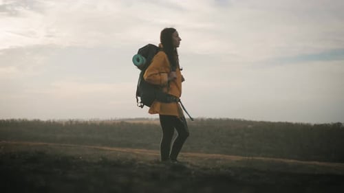Woman Hiking With Backpack on Rural Trail