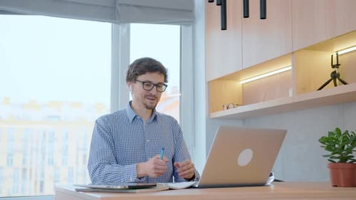Young Adult on Video Call in Home Office