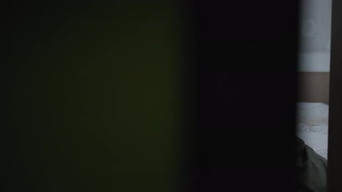 Woman and Boy Reading Together in Bedroom