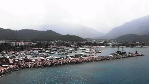 Marina with moored luxury white yachts and boats.