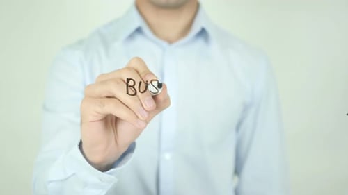 Man Writes Business Process on Clear Screen