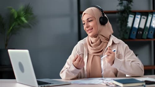Woman in Hijab Video Conferencing at Work