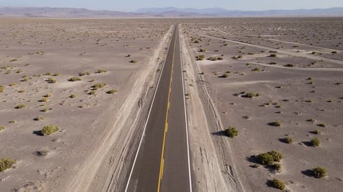 Aerial shot of a remote desert road with no cars in Nevada