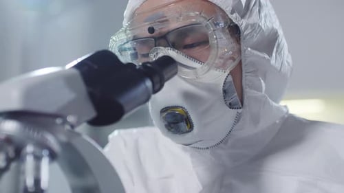 Asian Scientist Using Microscope
