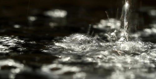 Pouring Fresh Water Causing Ripples and Splashes