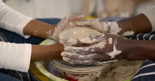 Hands Shaping Clay on Pottery Wheel