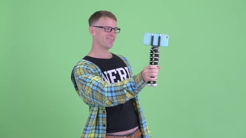 Man Filming with Smartphone on Green Screen