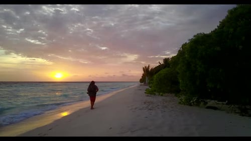 Lady alone posing on tranquil shore beach vacation by turquoise water and bright sandy background of