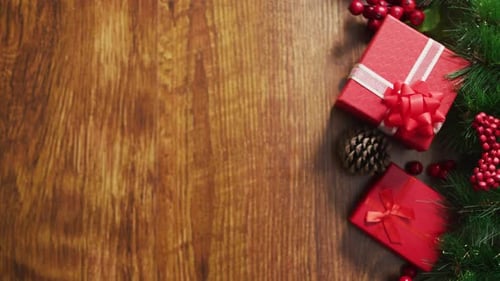 Christmas Gifts with Garland on Wood Background