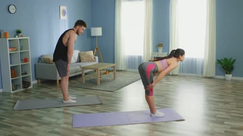Couple Doing Forward Bend Exercise at Home