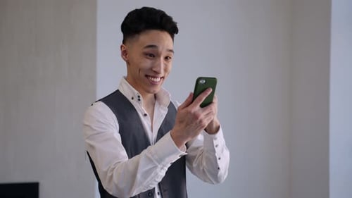 Excited Man Celebrates Good News on Smartphone