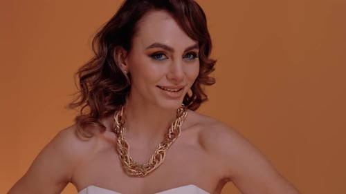 Woman with Makeup and Gold Chain Posing