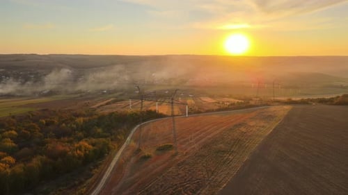 Golden Sunrise over Rural Landscape with Power Lines