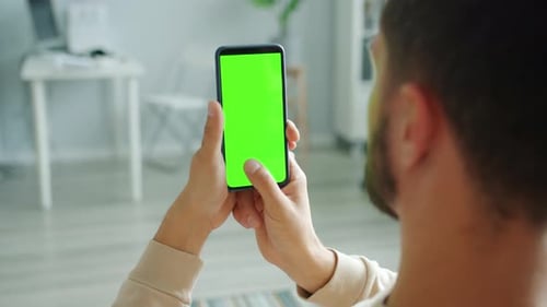 Slow Motion of Male Hand Swiping Smartphone with Green Screen Touching Browsing