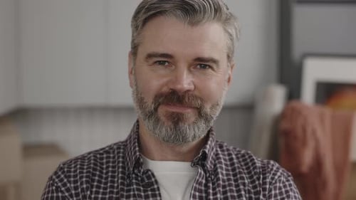 Friendly Man with Gray Hair Smiles at Camera