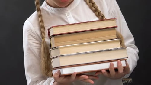 Young Student Holding Books in Close Up Shot