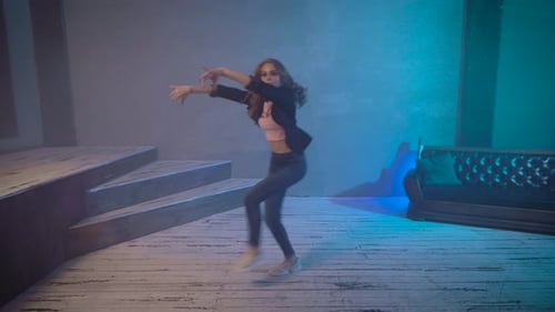 Slender Girl Dances in the Studio. Modern Stylish Dance.