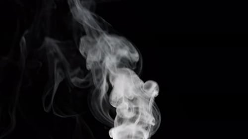 White Smoke Flowing on a Black Background