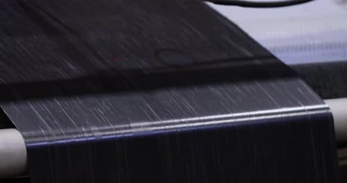 Black Material Being Processed by Machine