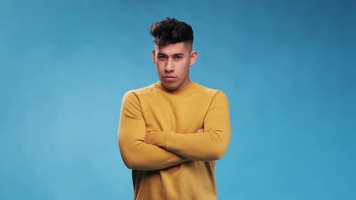 Young Man Stands with Serious Expression