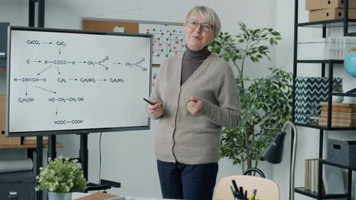 Portrait of Chemistry Teacher Working Online Pointing at Digital Screen and Speaking in Home Office
