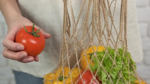 Adding Fresh Tomato to Reusable Produce Bag