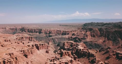 Der Grand Canyon ist rot. Um Steppe, Himmel und dunkle Felsen.