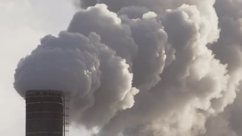 PANNING EPIC shot of thick billowing smoke from an industrial chimney