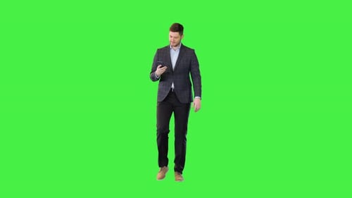 Man in Suit Walking with Smartphone on Green Screen