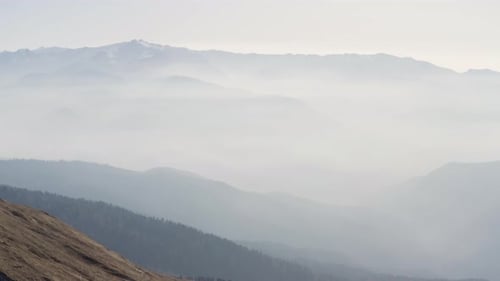 Scenic Mountain Range Covered in Hazy Fog