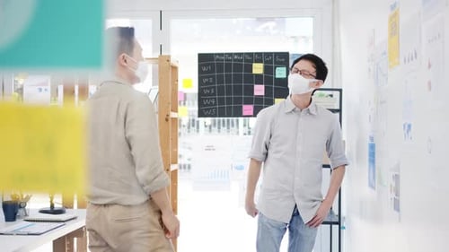 Office Colleagues Collaborate With Masks, Elbow Bump Greeting