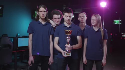 Esports Team Celebrates Victory with Trophy