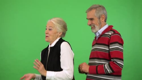 An Elderly Couple Dances, Then Stops and Smiles at the Camera - Green Screen Studio