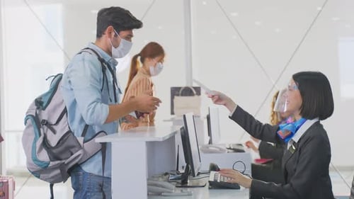 Passenger Checks In at Airport During Pandemic