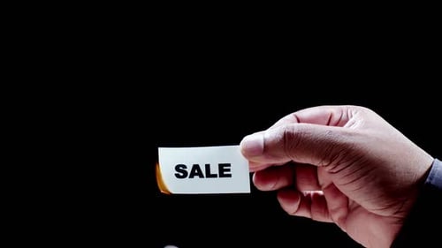 Card with "Sale" Message being Set on Fire