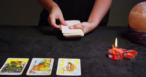 Hands Dealing Tarot Cards in a Mystic Setting