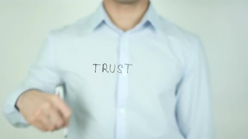 Writing the Word Trust on Clear Surface