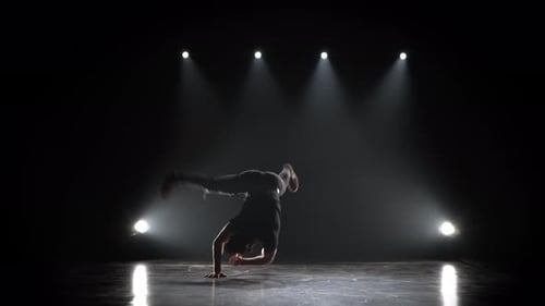Silhouette of a Talented Young Break Dancer. Hip Hop Street Dance on a Stage in Front of the
