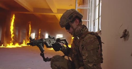 Soldier Kneeling with Rifle in Burning Building