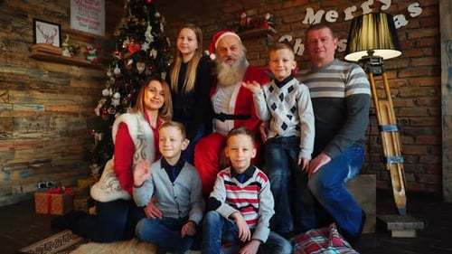 Cheerful Family Poses with Santa at Christmas